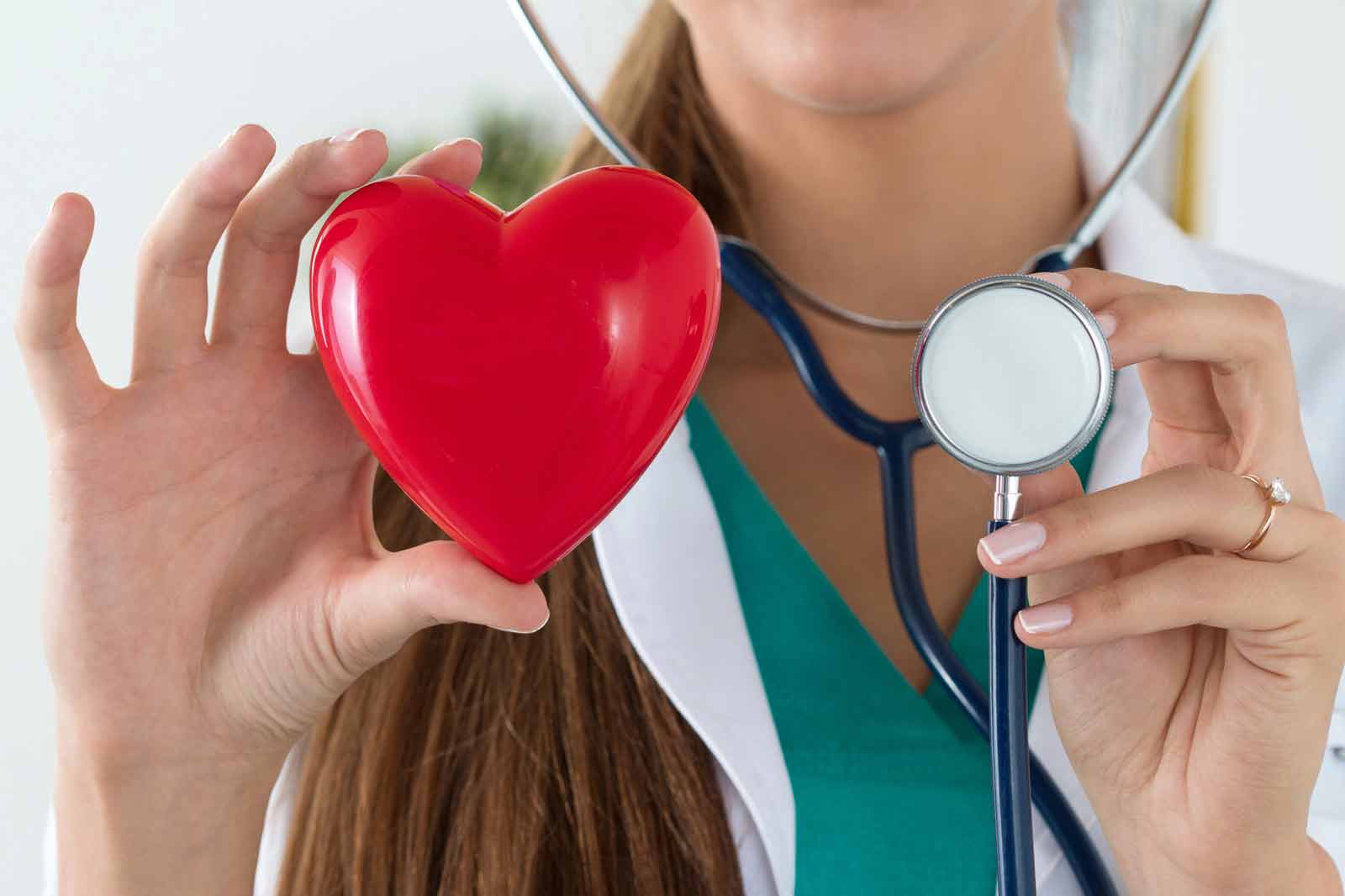 Doctor holding a red heart and a stethoscope