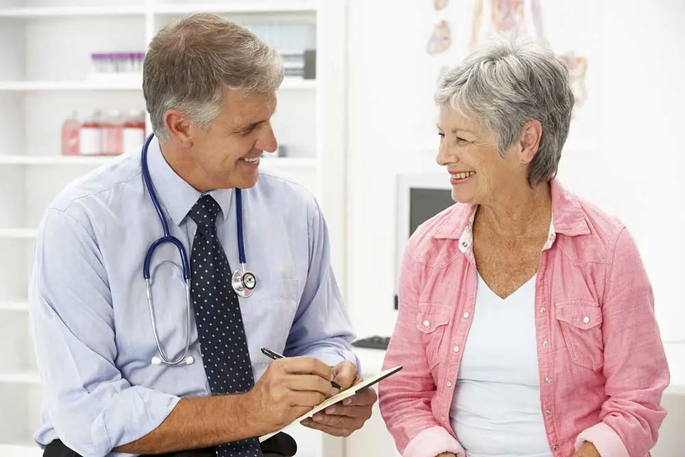 Smiling older couple reviewing documents together